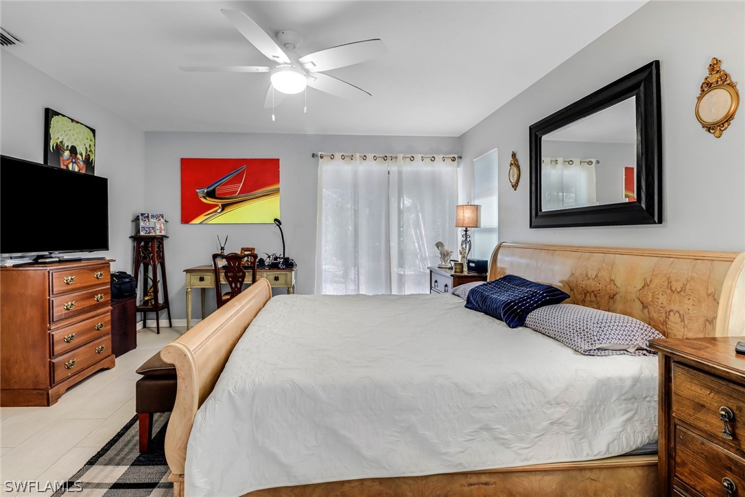 7523 Morgan Road Fort Myers, FL 33967 - Photo 20 of 25 a bedroom with a bed and a flat screen tv