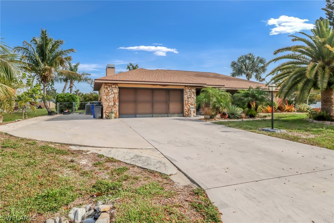 7523 Morgan Road Fort Myers, FL 33967 - Photo 2 of 25 a view of a house with a yard and potted plants