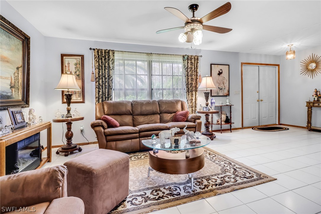 7523 Morgan Road Fort Myers, FL 33967 - Photo 7 of 25 a living room with furniture a chandelier and a window