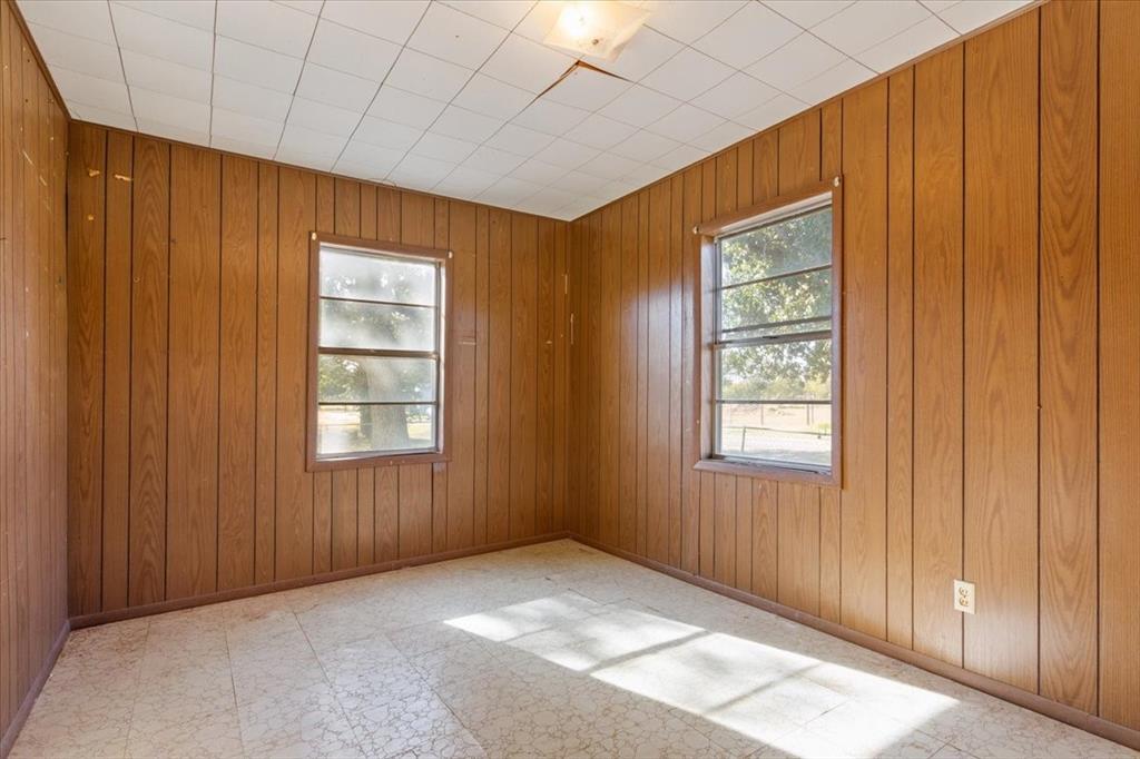 100 County Road 120 C Riesel, TX 76682 - Photo 13 of 25 Unfurnished room with light floors and wood walls