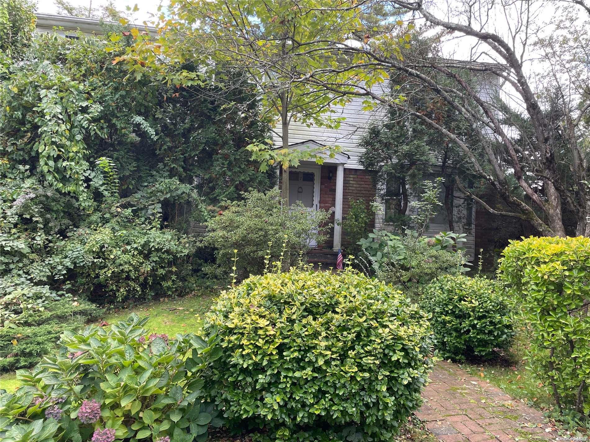 7 Sheffield Road Great Neck, NY 11021 - Photo 1 of 1 a view of a house with a flower garden