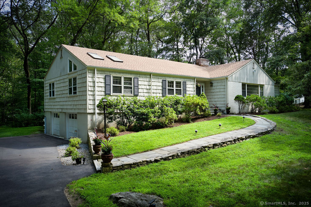 135 Foxwood Road Stamford, CT 06903 - Photo 1 of 1 a front view of a house with a garden