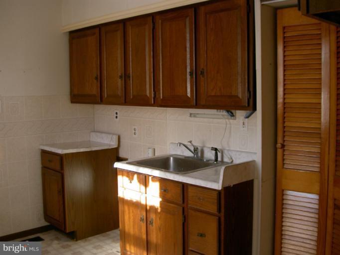319 Trappe Road Baltimore, MD 21222 - Photo 3 of 8 a kitchen with a sink and cabinets