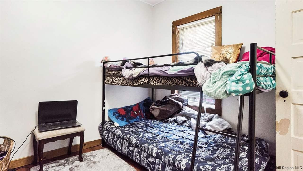 879 Samsonville Road Kerhonkson, NY 12446 - Photo 12 of 16 a bedroom with a bed a couch and a potted plant