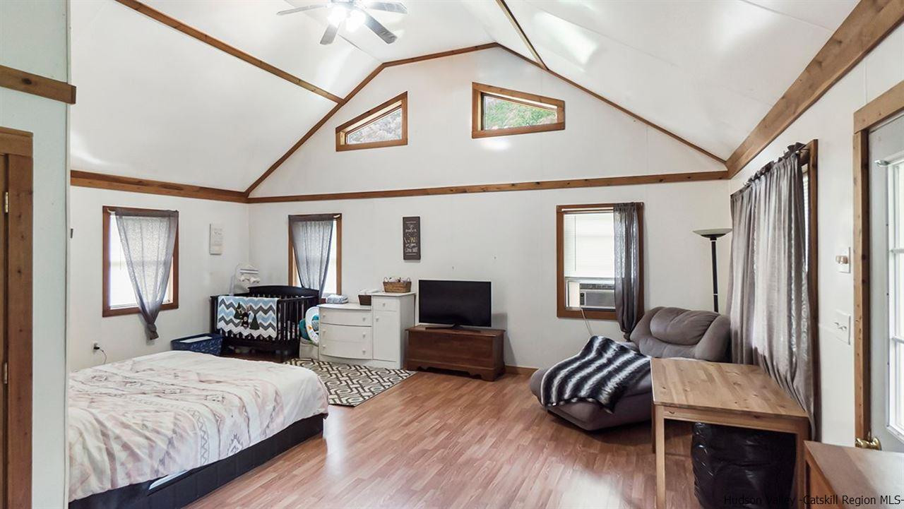 879 Samsonville Road Kerhonkson, NY 12446 - Photo 2 of 16 a bedroom with furniture and a flat screen tv