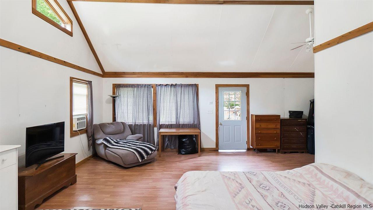 879 Samsonville Road Kerhonkson, NY 12446 - Photo 6 of 16 a bedroom with furniture and a flat screen tv