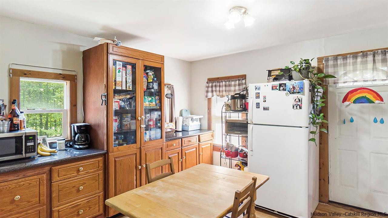 879 Samsonville Road Kerhonkson, NY 12446 - Photo 7 of 16 a white refrigerator freezer sitting inside of a kitchen