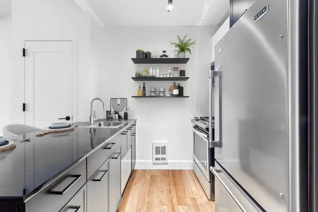 a kitchen with a sink and refrigerator