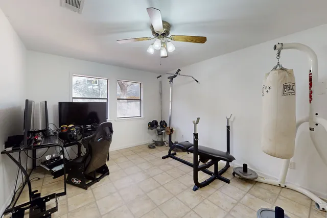 a living room with furniture flat screen tv and wooden floor