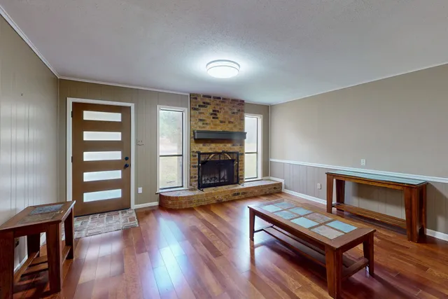 a living room with furniture and a fireplace