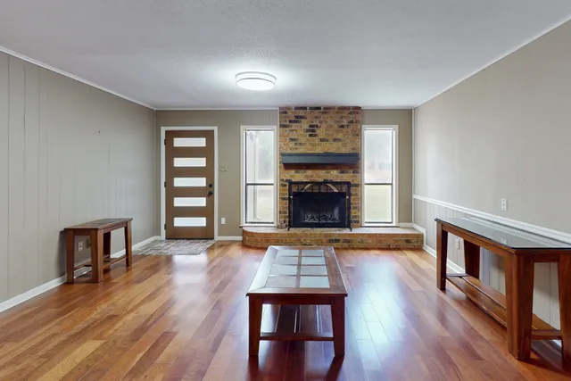a living room with furniture and a fireplace