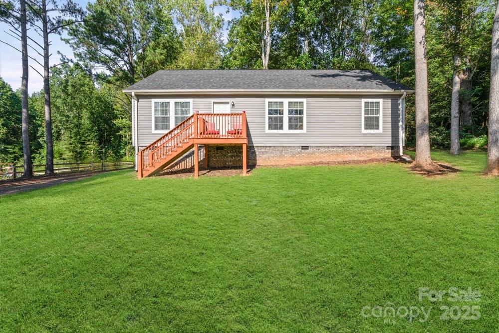 a view of a house with a yard and sitting area
