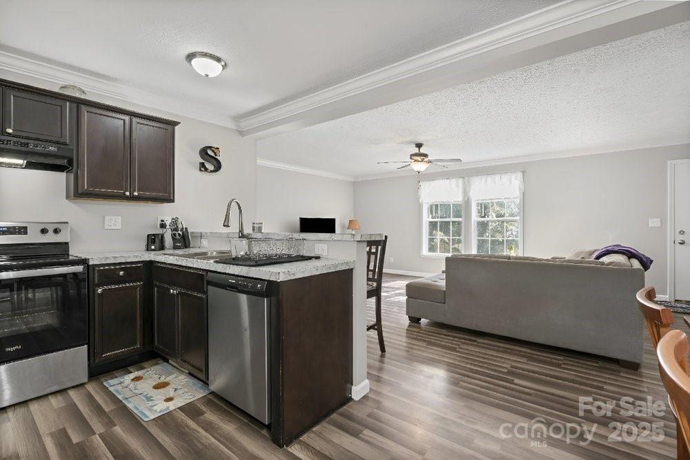 402 Shiloh Road Statesville, NC 28677 - Photo 11 of 34 a kitchen with granite countertop a sink and a stove top oven