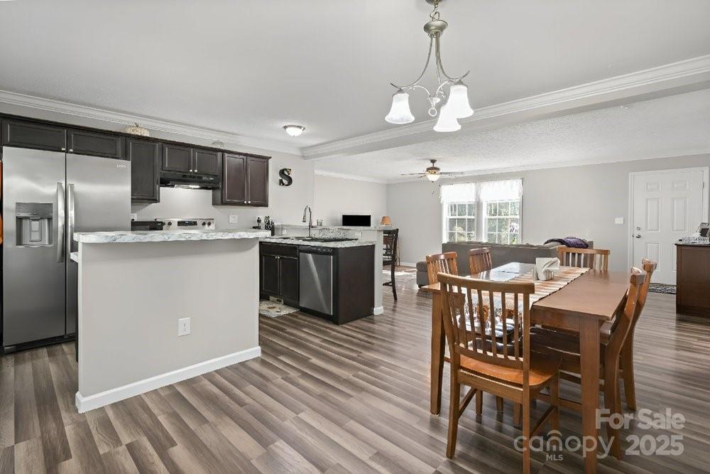 402 Shiloh Road Statesville, NC 28677 - Photo 12 of 34 a kitchen with stainless steel appliances granite countertop a sink a stove a refrigerator dining table and chairs