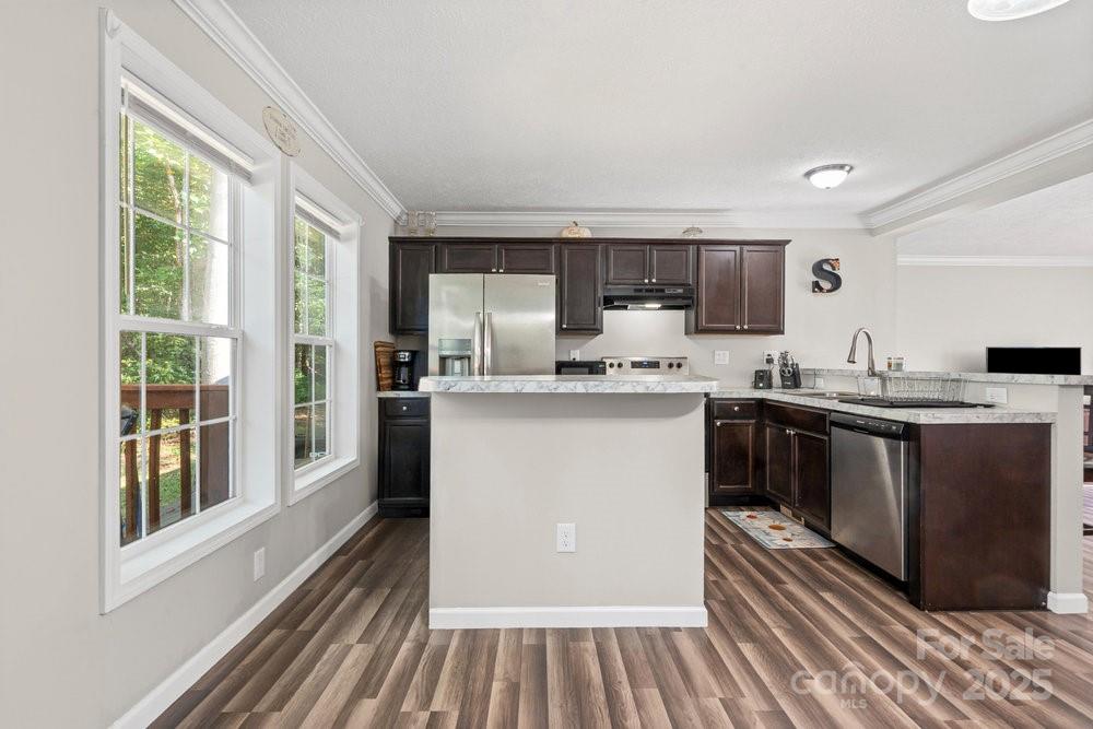 402 Shiloh Road Statesville, NC 28677 - Photo 13 of 34 a kitchen with a sink stove and cabinets