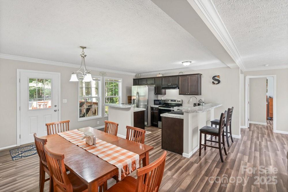 402 Shiloh Road Statesville, NC 28677 - Photo 15 of 34 a view of a dining room with furniture window and wooden floor