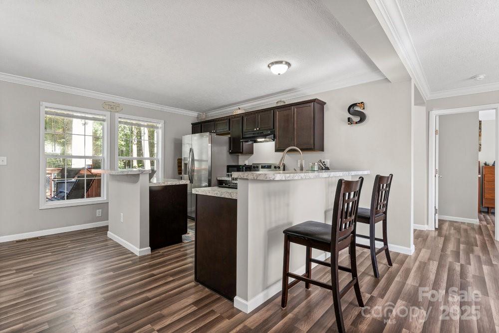 402 Shiloh Road Statesville, NC 28677 - Photo 16 of 34 a kitchen with a table chairs refrigerator and microwave