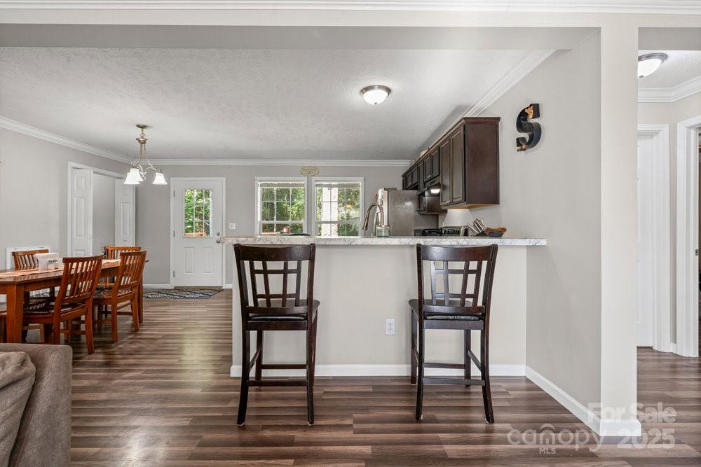 402 Shiloh Road Statesville, NC 28677 - Photo 17 of 34 a kitchen with stainless steel appliances kitchen island granite countertop a table chairs stove a sink and dishwasher