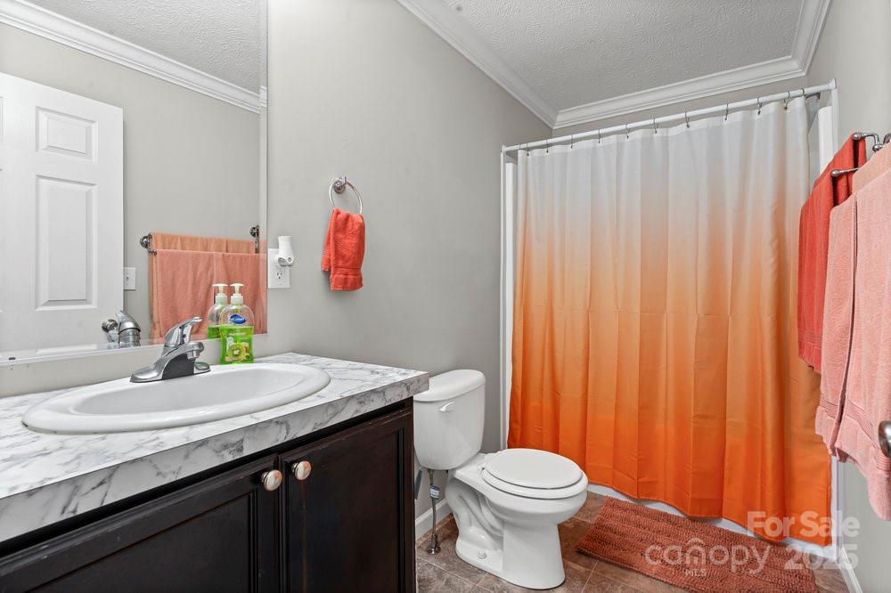 402 Shiloh Road Statesville, NC 28677 - Photo 20 of 34 a bathroom with a sink vanity mirror and toilet