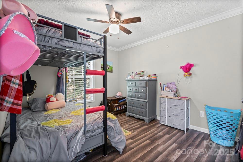 402 Shiloh Road Statesville, NC 28677 - Photo 21 of 34 a bedroom with furniture and a wooden floor