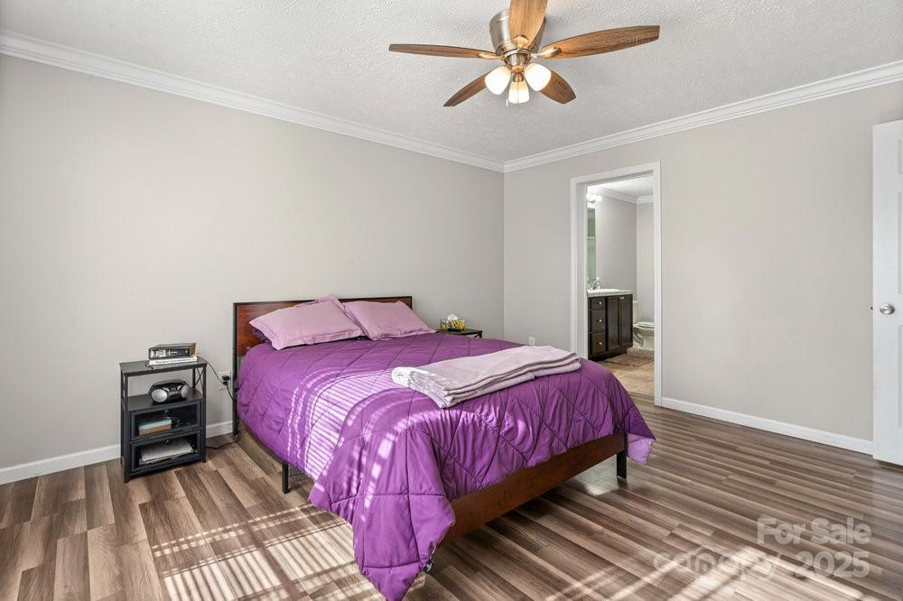 402 Shiloh Road Statesville, NC 28677 - Photo 22 of 34 a bedroom with a bed and wooden floor