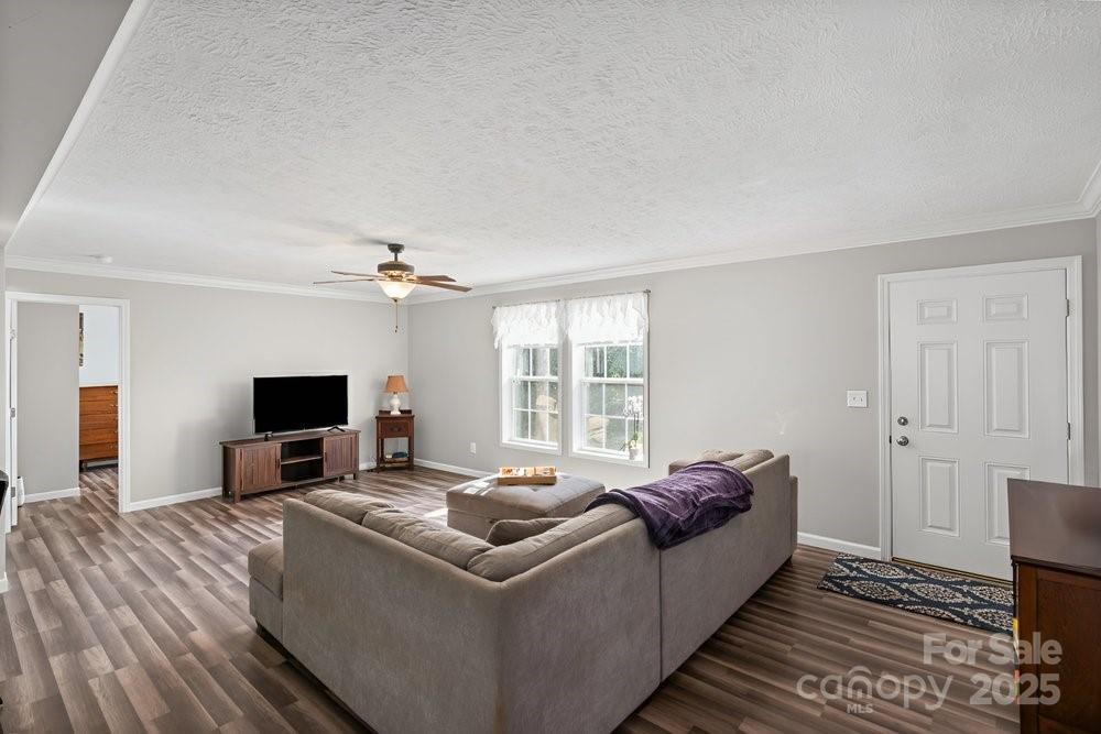 402 Shiloh Road Statesville, NC 28677 - Photo 6 of 34 a living room with furniture a flat screen tv and a fireplace