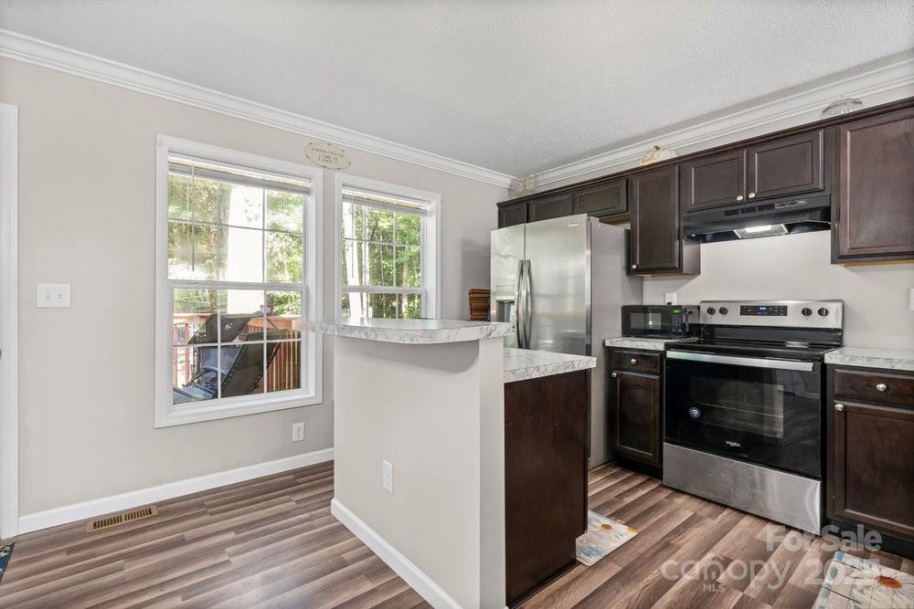 402 Shiloh Road Statesville, NC 28677 - Photo 10 of 34 a kitchen with stainless steel appliances a stove microwave and refrigerator