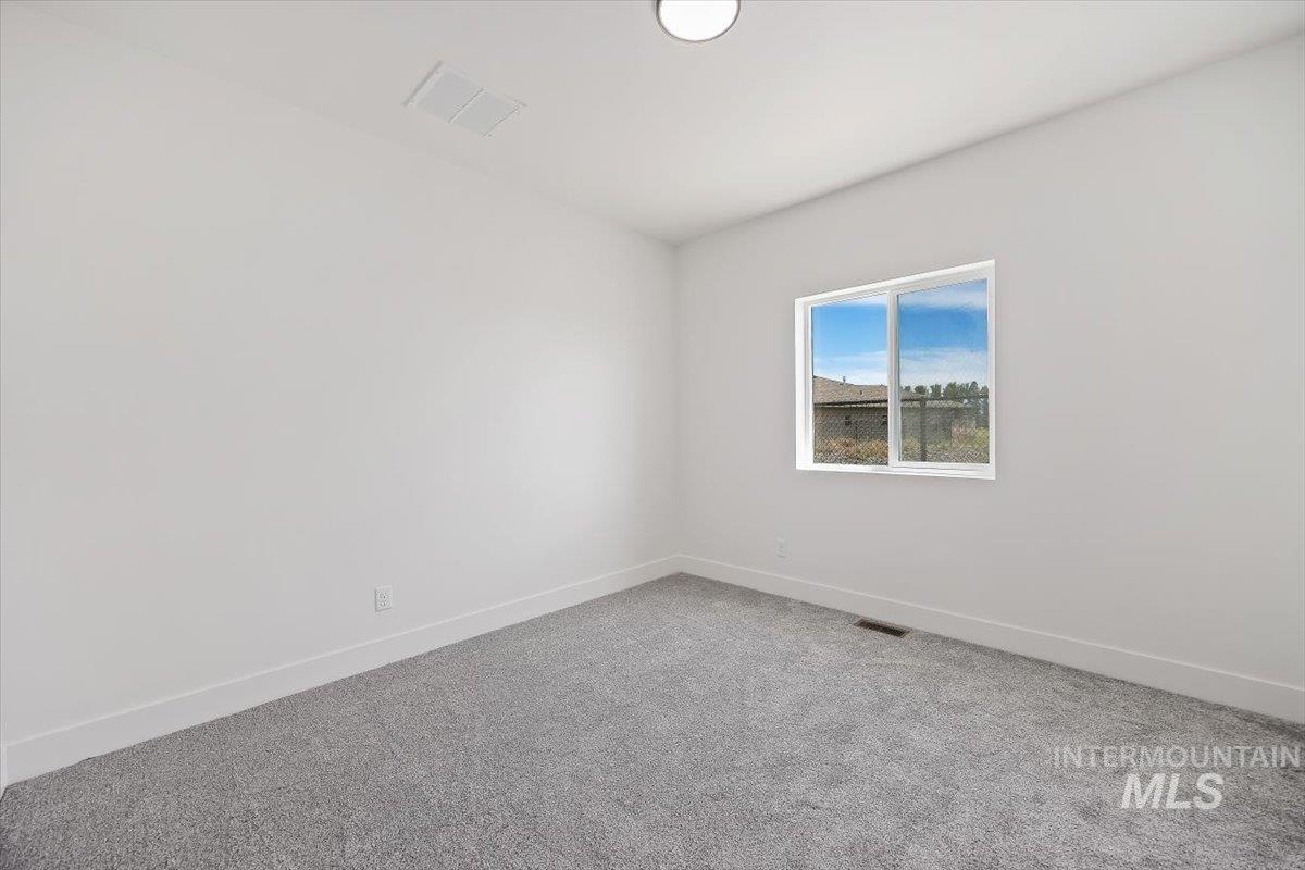 2005 Sparrow Street Rupert, ID 83350 - Photo 23 of 30 Carpeted room with a flush-mount ceiling light and a window with white trim