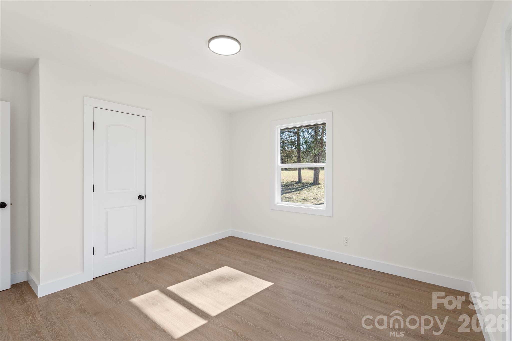 3991 State Rd S-29-330 Lancaster, SC 29720 - Photo 16 of 25 an empty room with wooden floor and windows