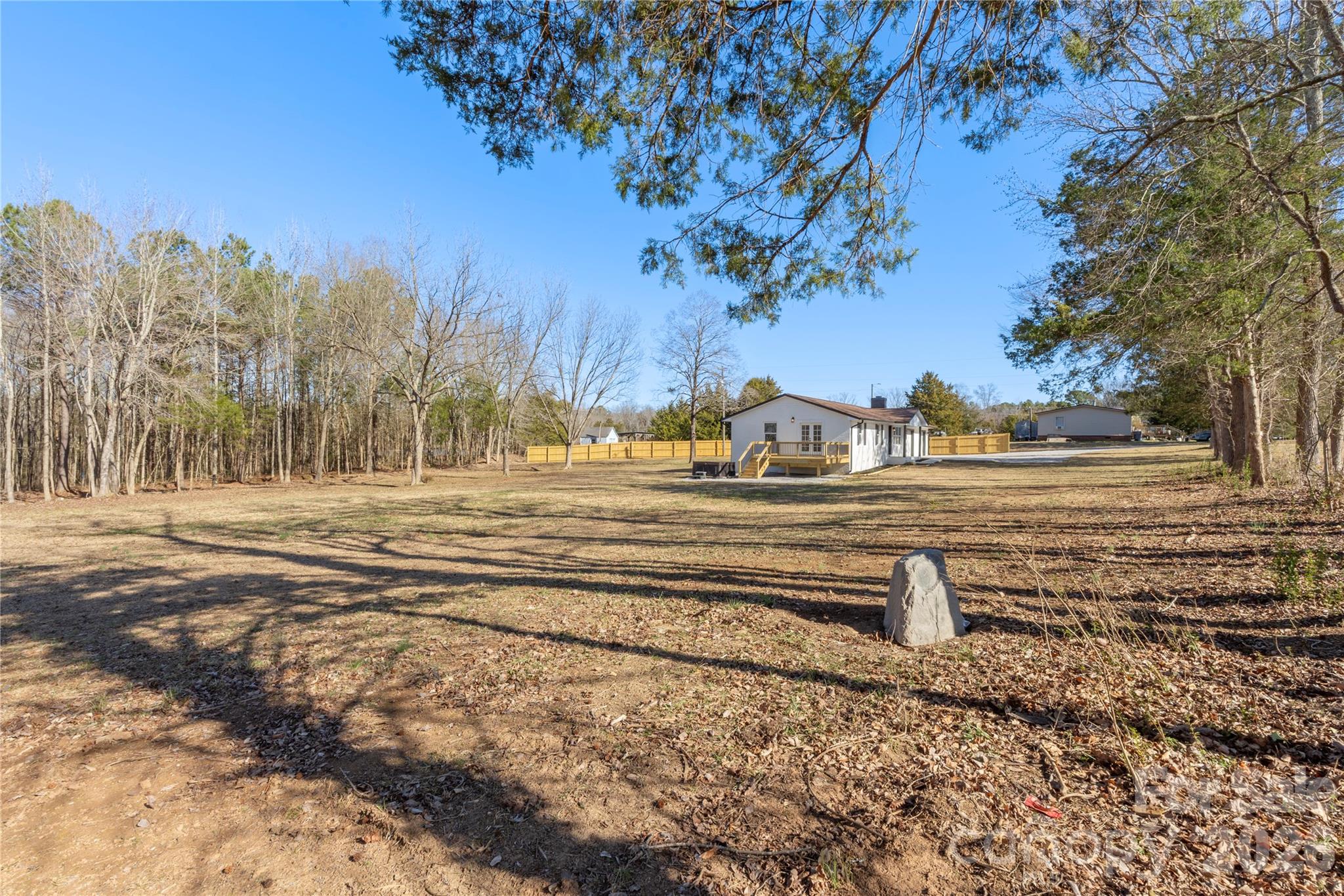 3991 State Rd S-29-330 Lancaster, SC 29720 - Photo 23 of 25 a view of a yard with trees in the background