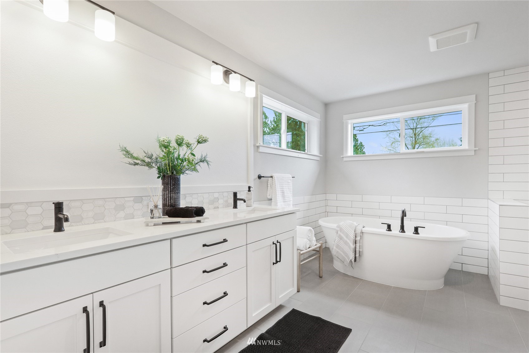 1305 197th Place Southeast Bothell, WA 98012 - Photo 21 of 33 a bathroom with a double vanity sink and a bathtub