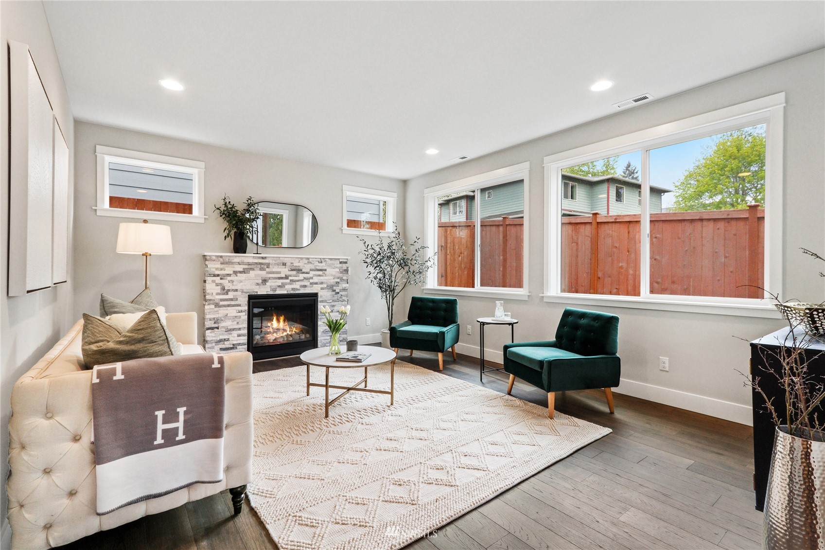 1305 197th Place Southeast Bothell, WA 98012 - Photo 8 of 33 a living room with furniture a large window and a fireplace