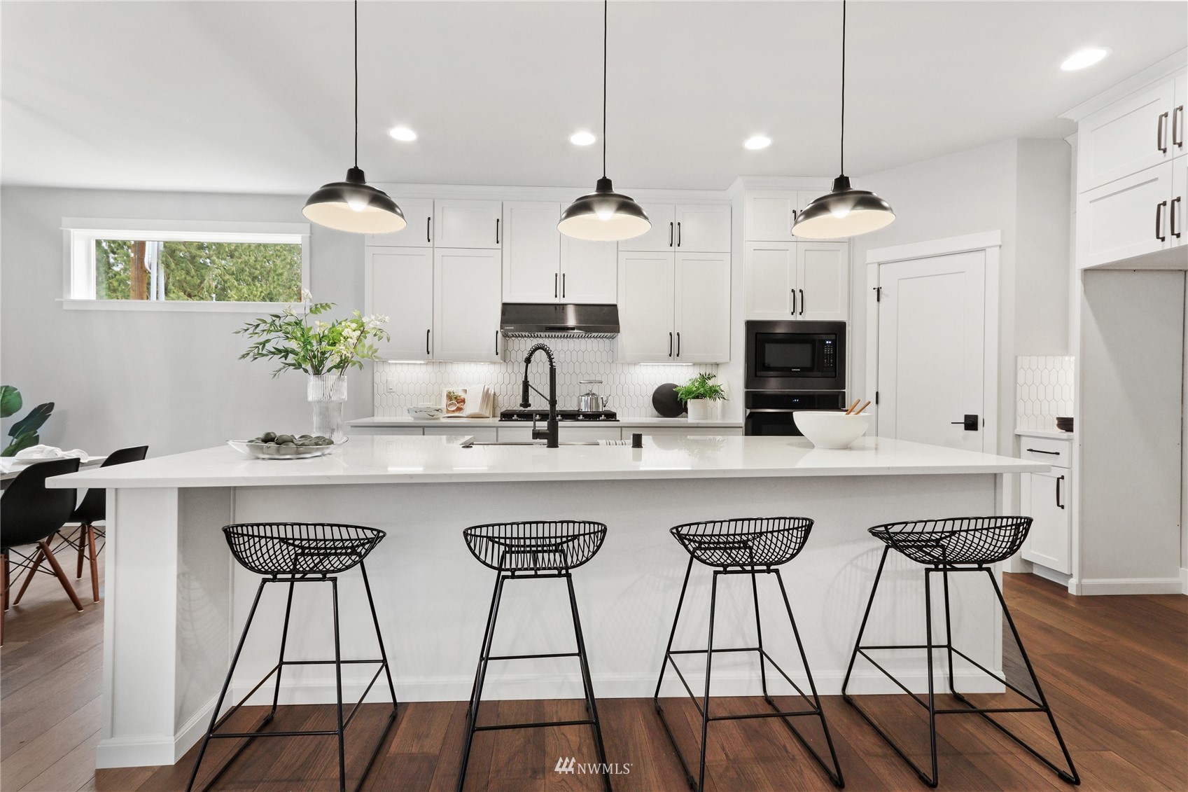 1305 197th Place Southeast Bothell, WA 98012 - Photo 10 of 33 a kitchen with stainless steel appliances a kitchen island a stove a table and chairs in it