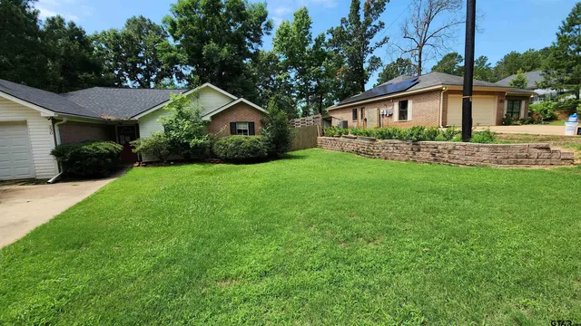 a front view of a house with a yard and porch