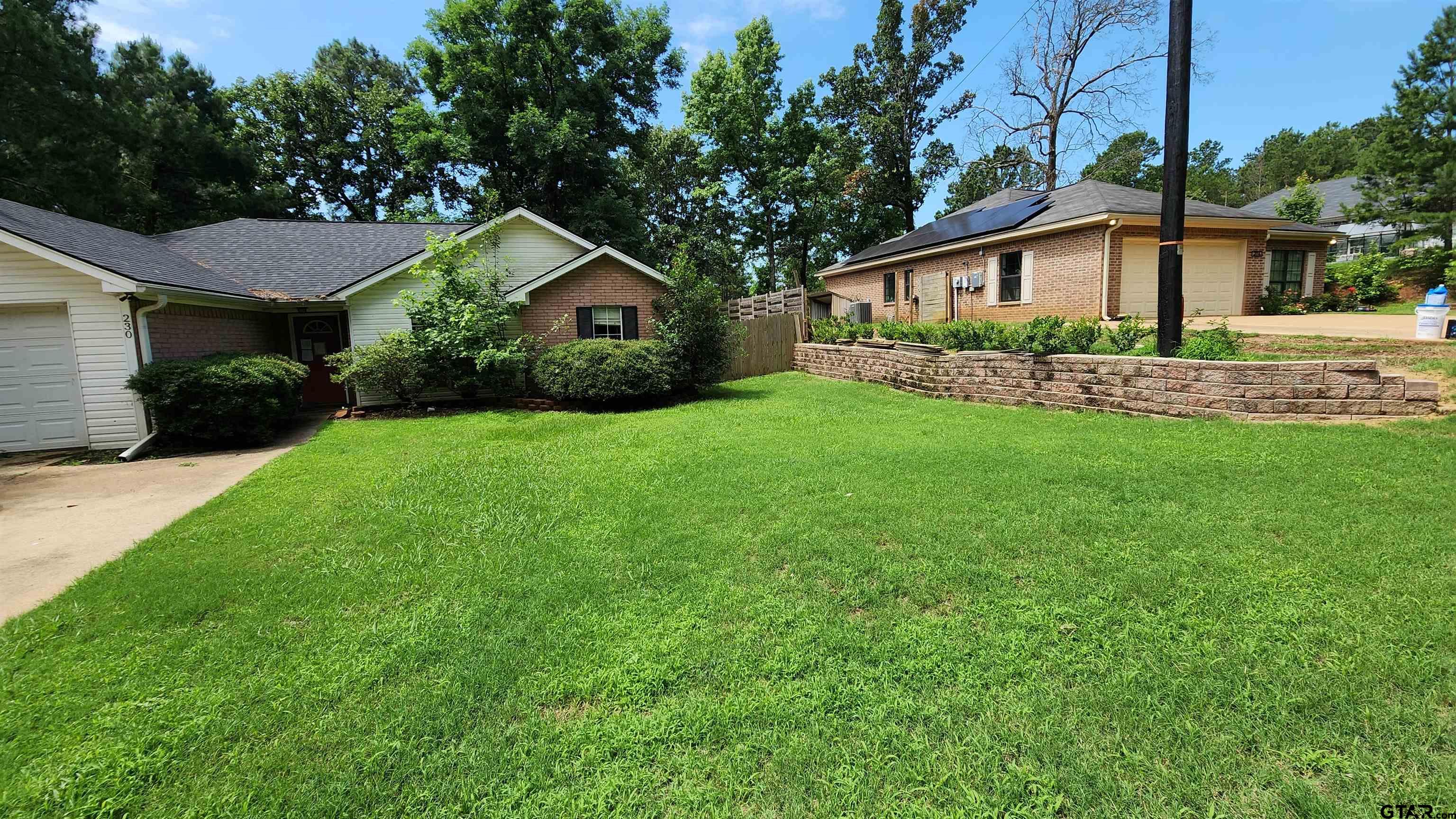 a front view of a house with a yard and porch