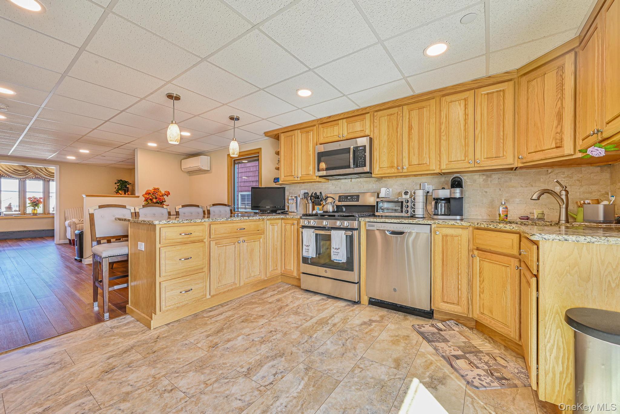 20 West 18th Road Queens, NY 11693 - Photo 26 of 41 a kitchen with white cabinets and appliances