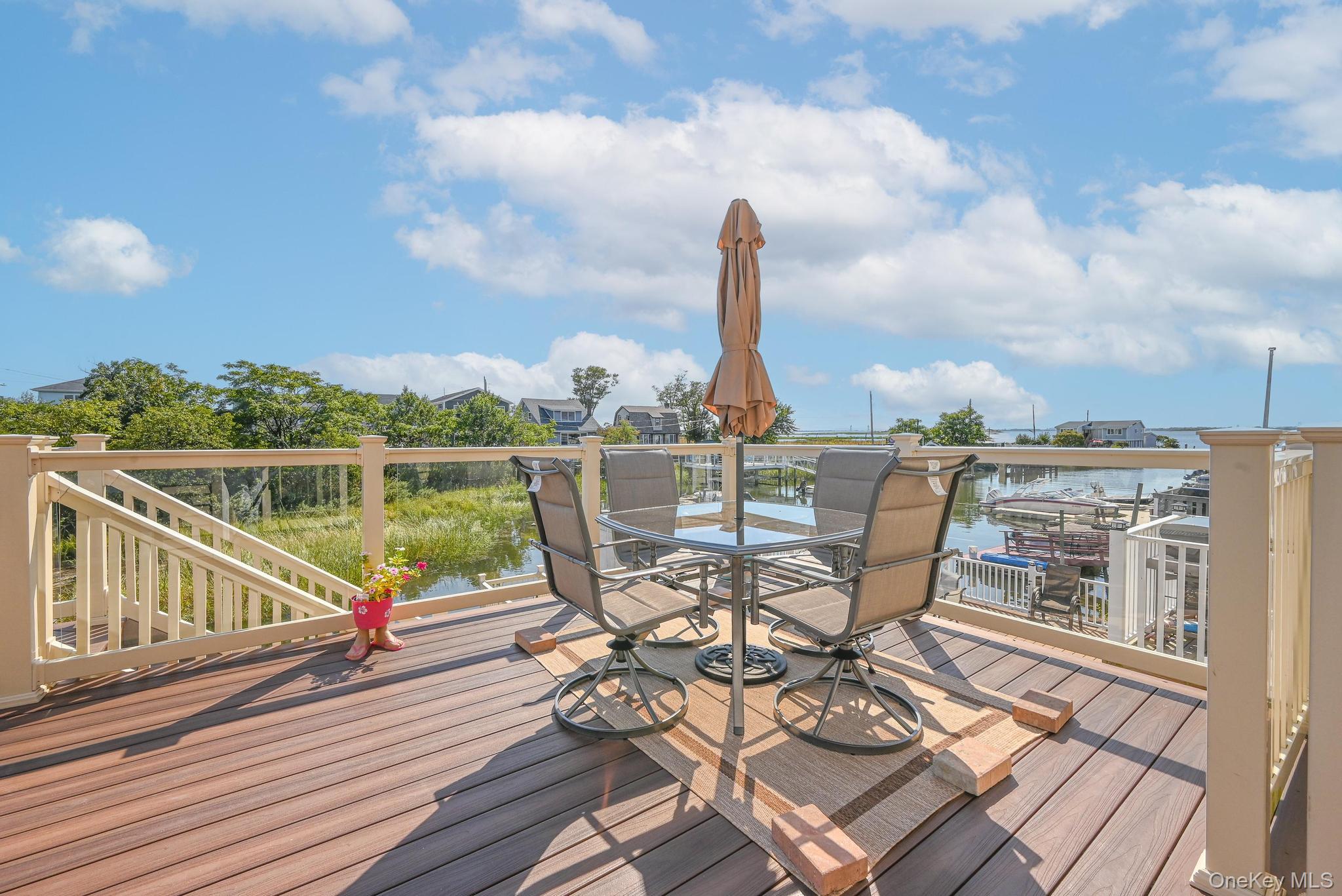 20 West 18th Road Queens, NY 11693 - Photo 4 of 41 a view of a balcony with wooden floor and outdoor seating