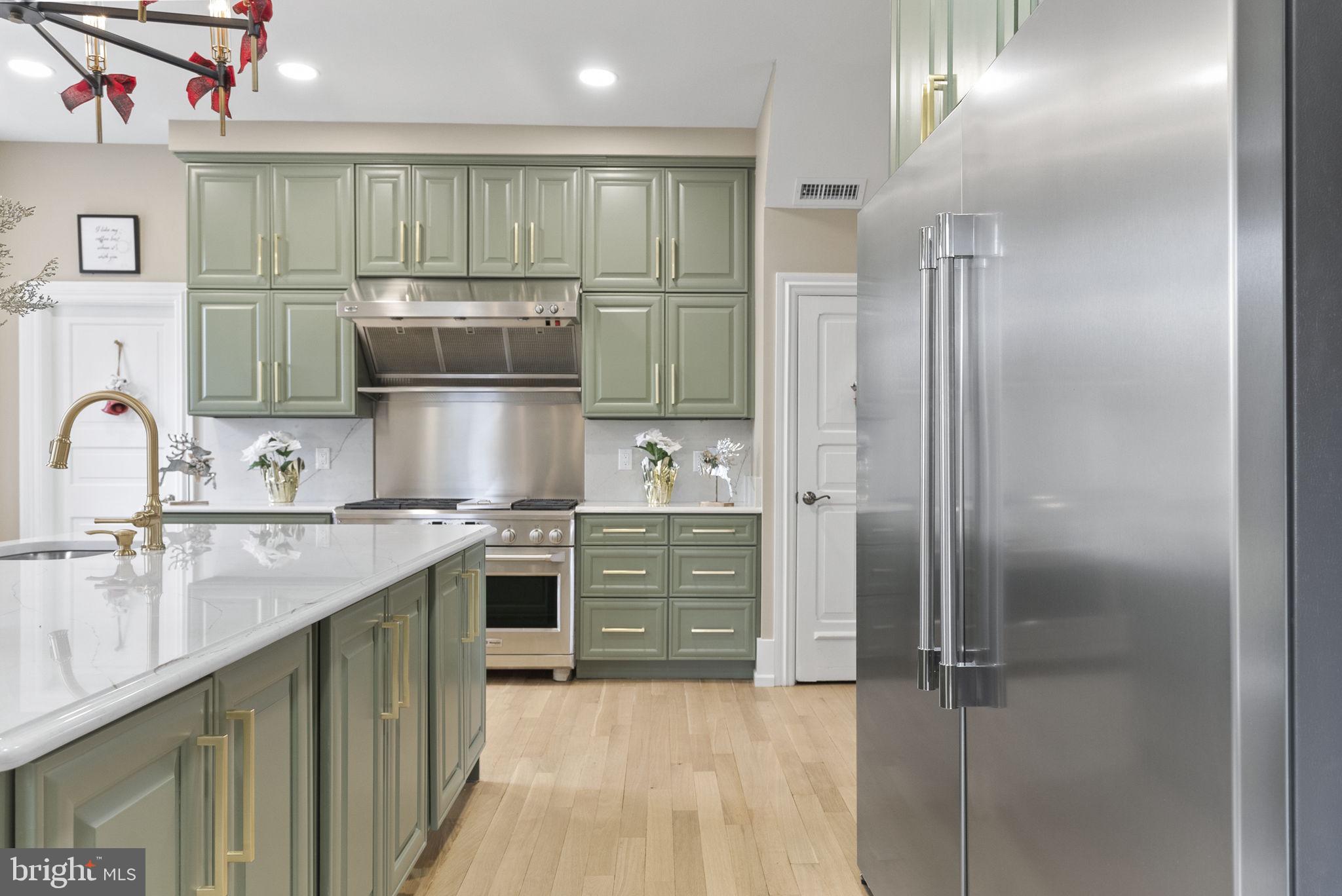 231 Woodlane Road Edgewater Park, NJ 08010 - Photo 17 of 95 a kitchen with kitchen island stainless steel appliances a sink stove and refrigerator