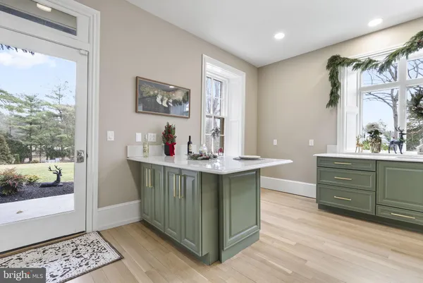 a bathroom with a toilet a sink a mirror and a window