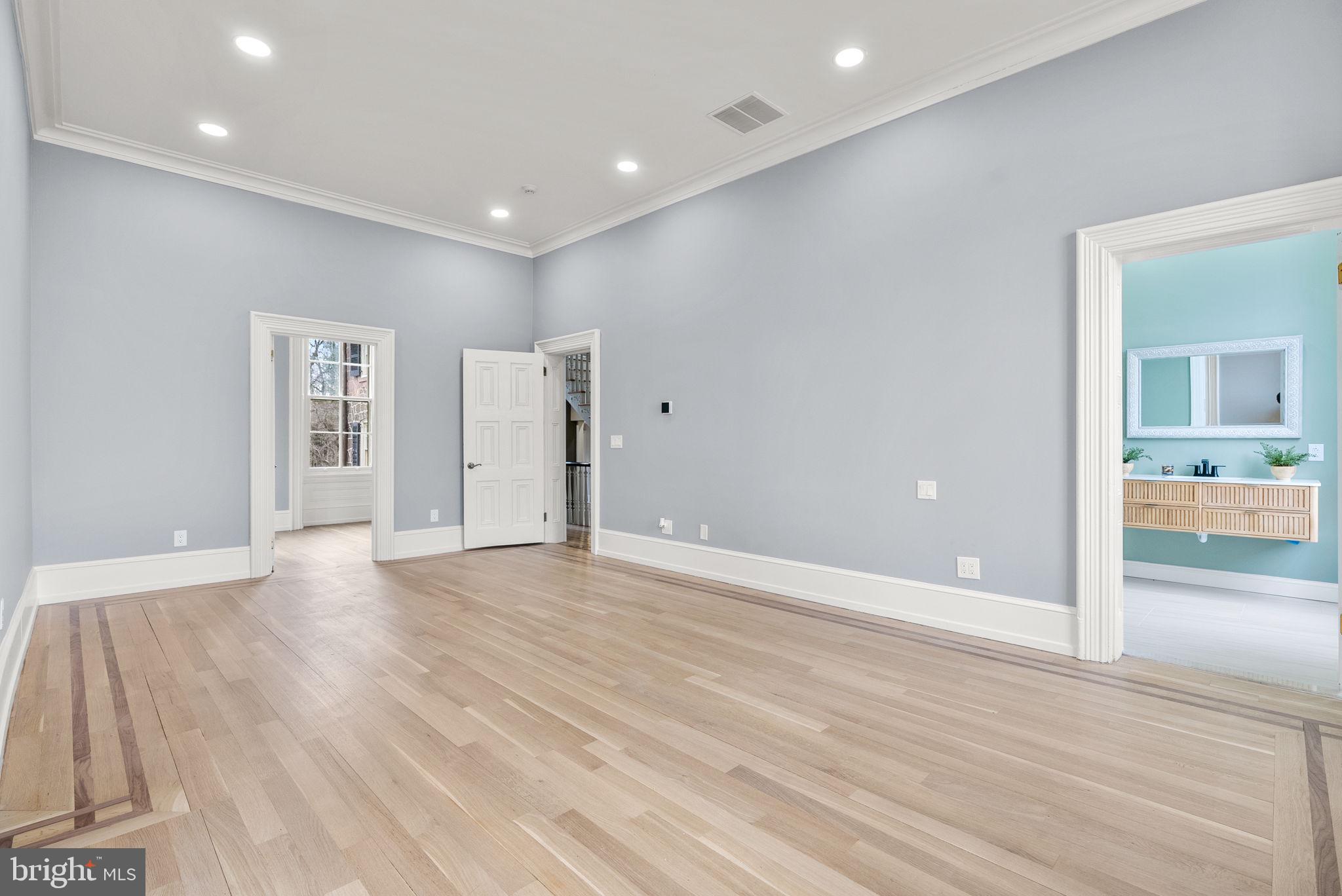 231 Woodlane Road Edgewater Park, NJ 08010 - Photo 46 of 95 a view of an empty room with wooden floor and a bathroom