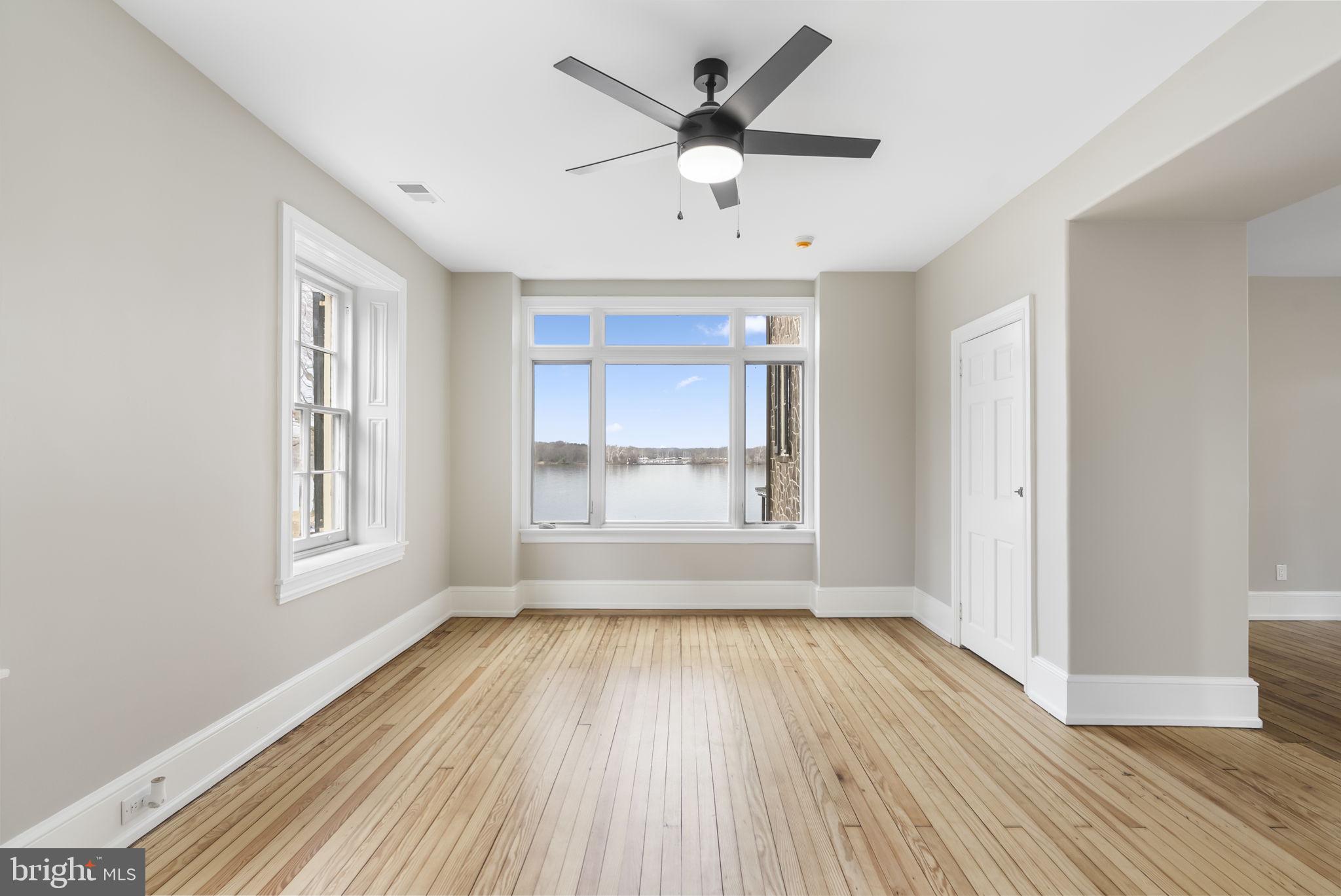 231 Woodlane Road Edgewater Park, NJ 08010 - Photo 56 of 95 a view of an empty room with a window and wooden floor