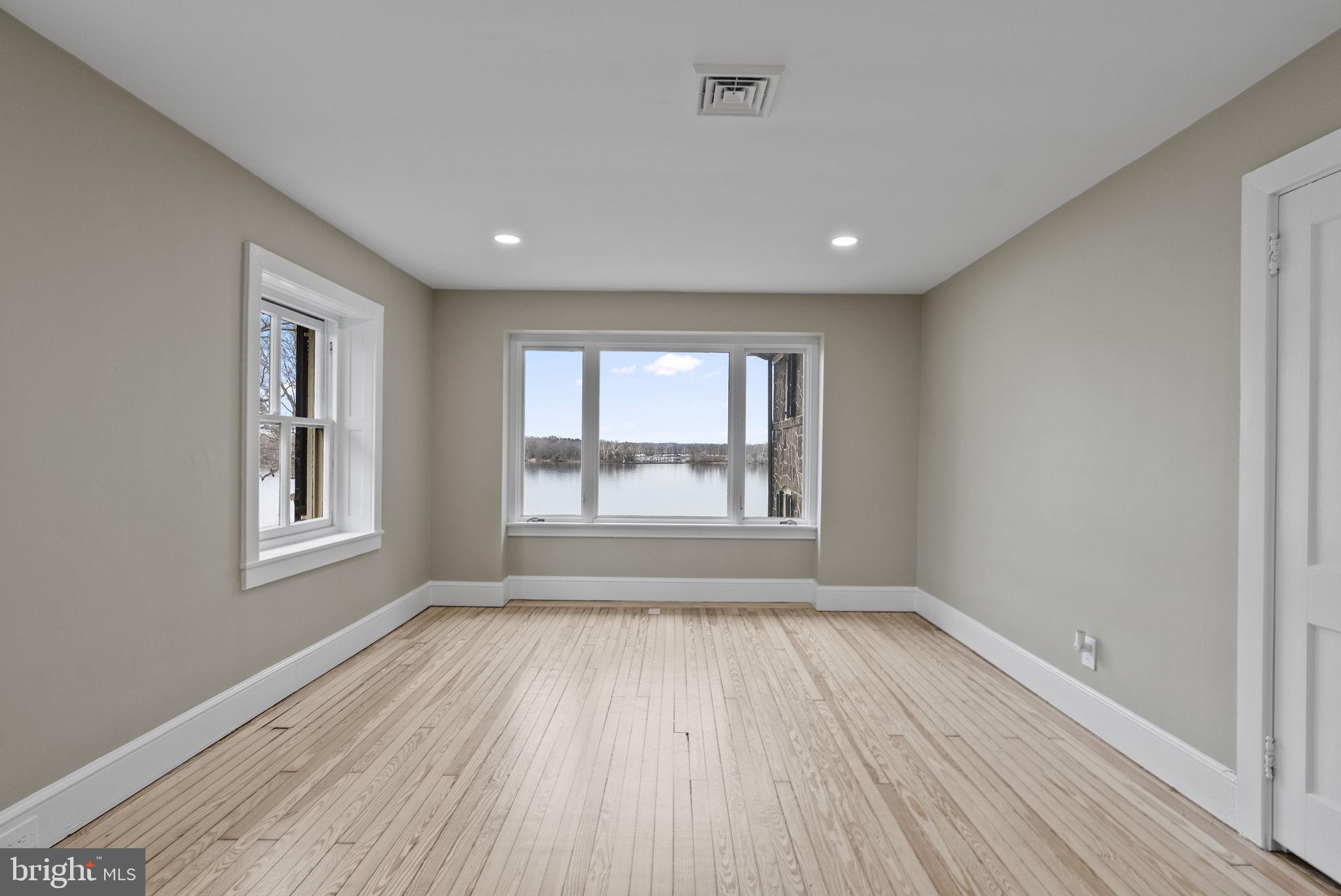 231 Woodlane Road Edgewater Park, NJ 08010 - Photo 75 of 95 a view of an empty room with wooden floor and a window