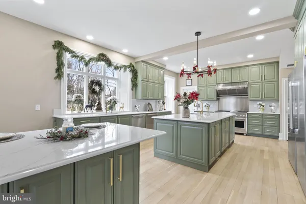 a kitchen with stainless steel appliances granite countertop a sink and a stove