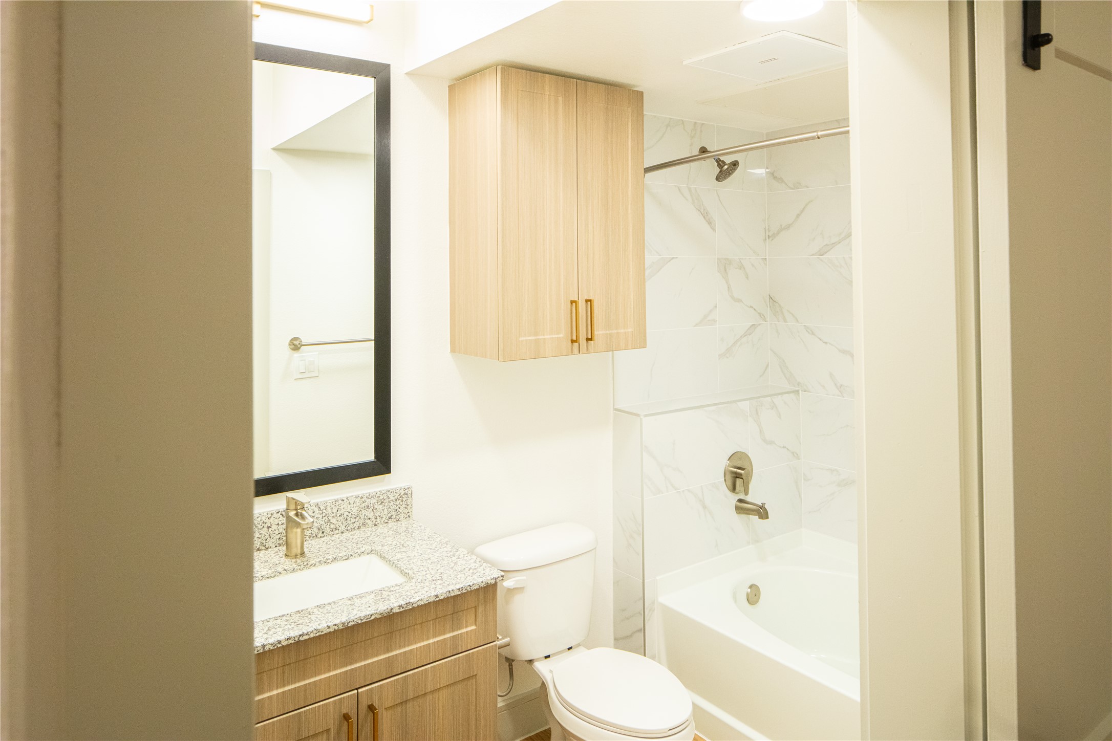 3100 Scofield Ridge Parkway, Unit 1403 Austin, TX 78727 - Photo 12 of 21 a bathroom with a granite countertop sink toilet and shower