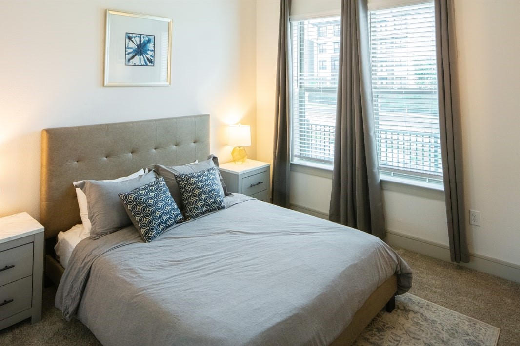 3100 Scofield Ridge Parkway, Unit 1403 Austin, TX 78727 - Photo 4 of 21 a large bed sitting in a bedroom next to a window