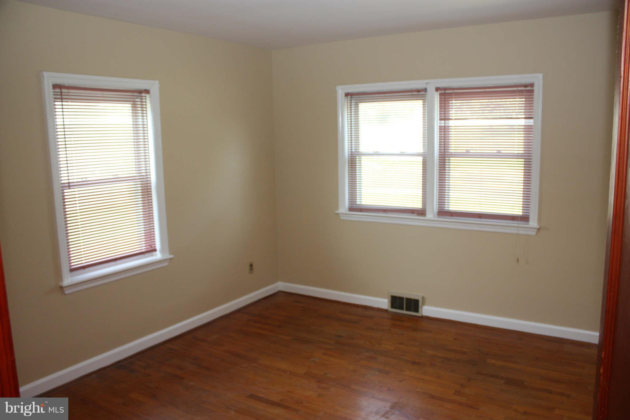 5707 Shookstown Road Frederick, MD 21702 - Photo 14 of 22 an empty room with a window and wooden floor