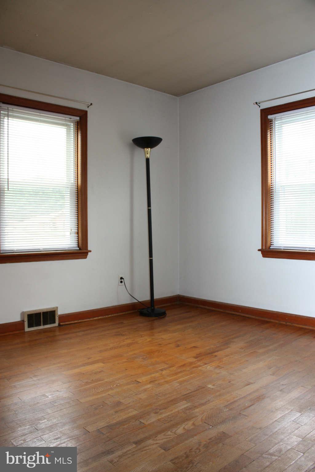 5707 Shookstown Road Frederick, MD 21702 - Photo 15 of 22 a view of an empty room with wooden floor and a window