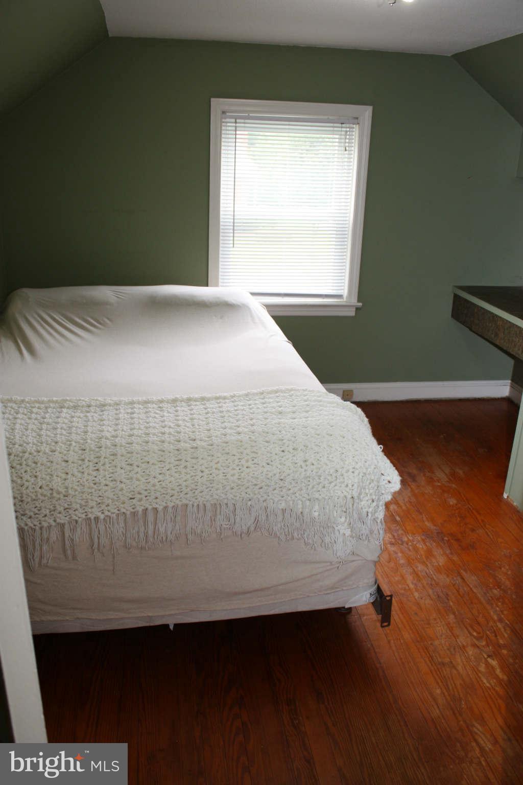 5707 Shookstown Road Frederick, MD 21702 - Photo 18 of 22 a bed sitting in a bedroom next to a window