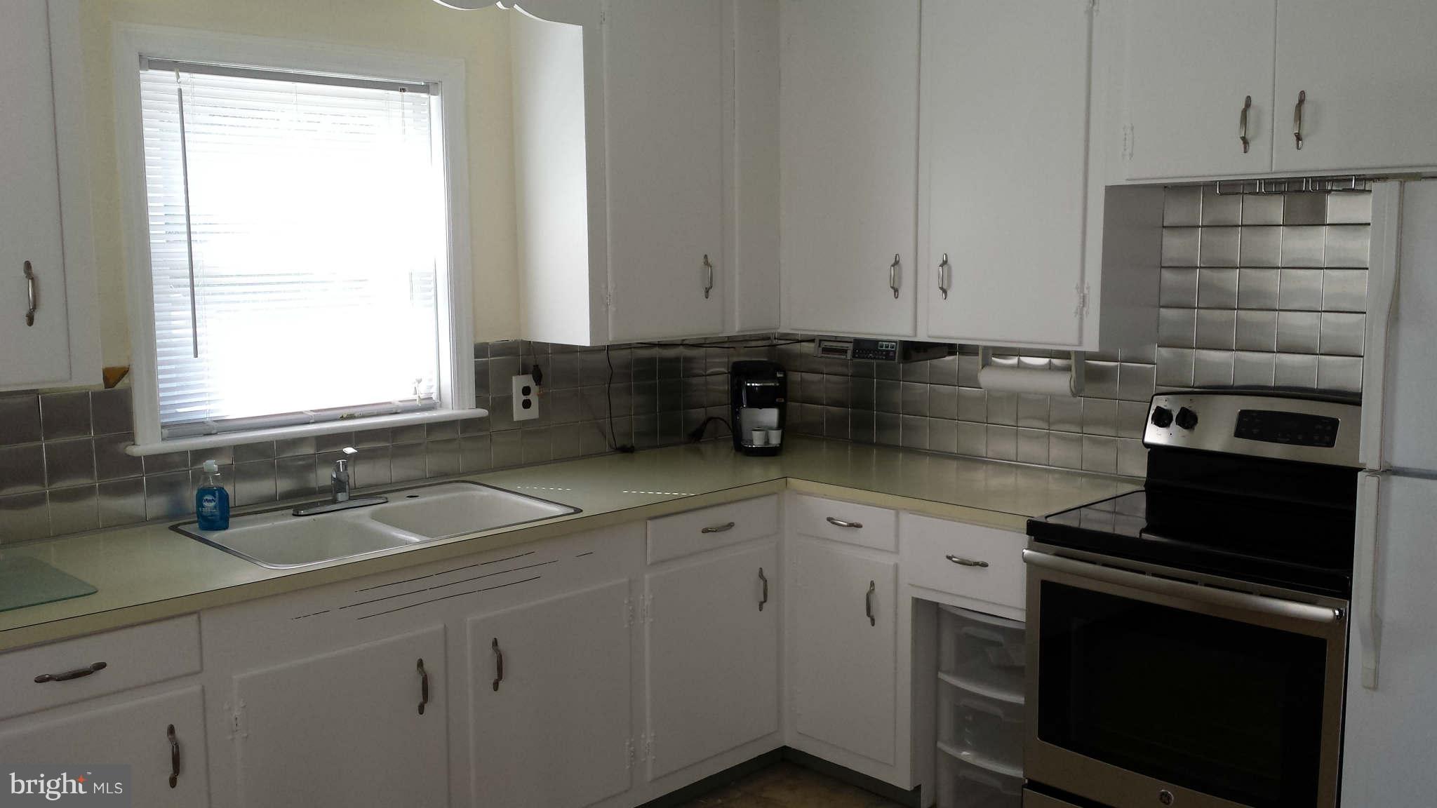 5707 Shookstown Road Frederick, MD 21702 - Photo 9 of 22 a kitchen with granite countertop a sink stainless steel appliances and cabinets