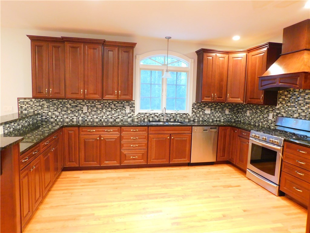 120 Arcadia Road Hopkinton, RI 02832 - Photo 9 of 36 The large kitchen with separate breakfast area features quality cabinets, soft close drawers, granite, mosaic tile backsplash & new stainless gas range and refrigerator.